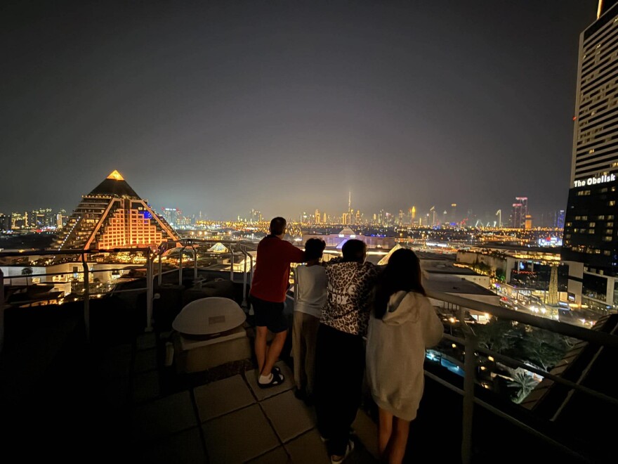 Whitney Reynold’s family looks out onto Dubai the night that rockets began being launched into the Middle East following the U.S.’ air operations in Iran.