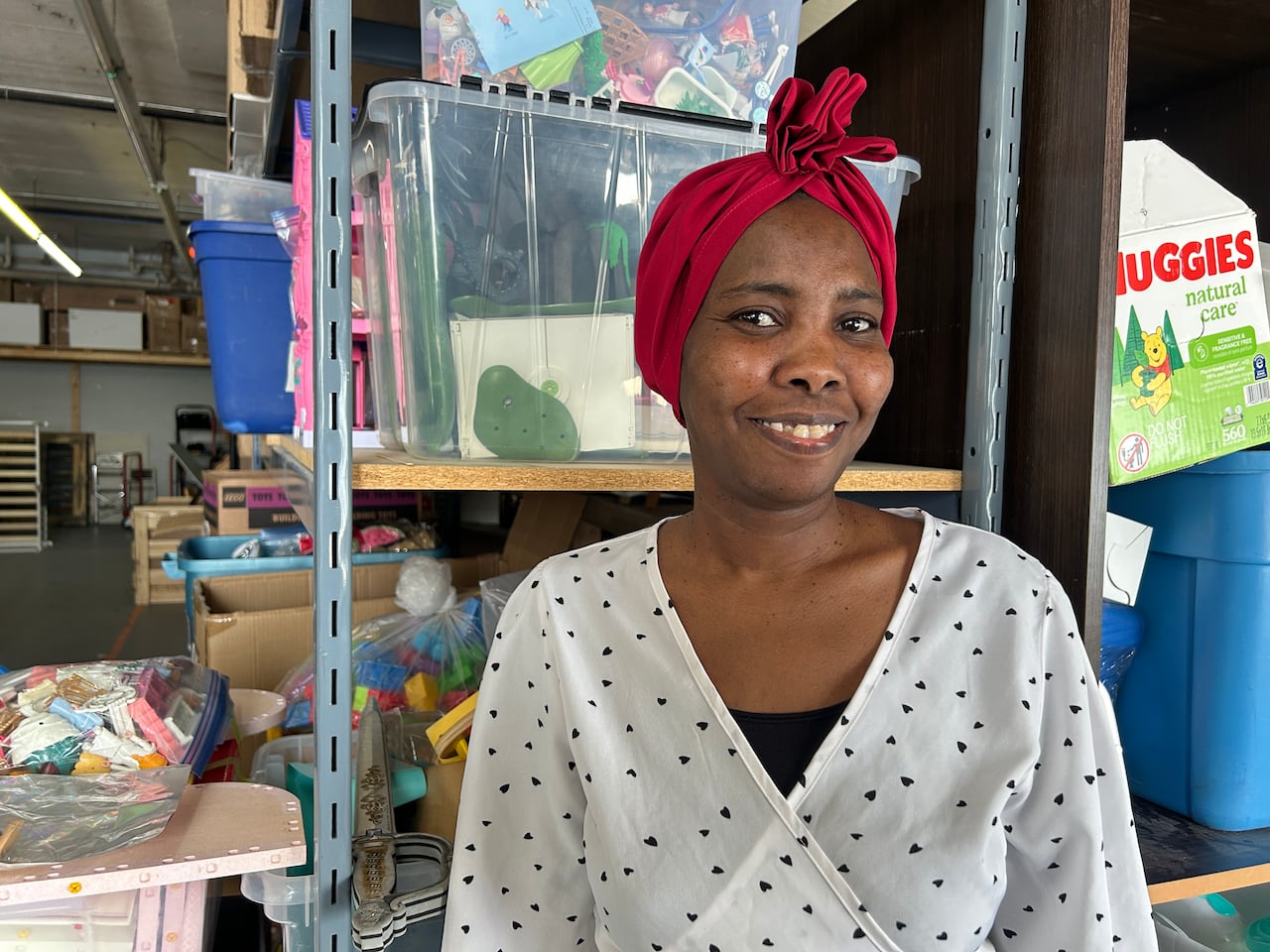 A woman in a white shirt smiles.
