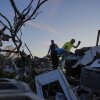 Family friends of Kristie and James Sexton, help look through the debris of Sexton's home after a tornado passed through the area, Saturday, May 17, 2025, in London, Ky. (AP Photo/Carolyn Kaster)