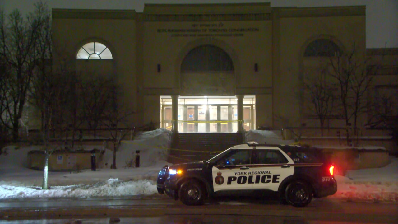 police car in front of a synagogue.
