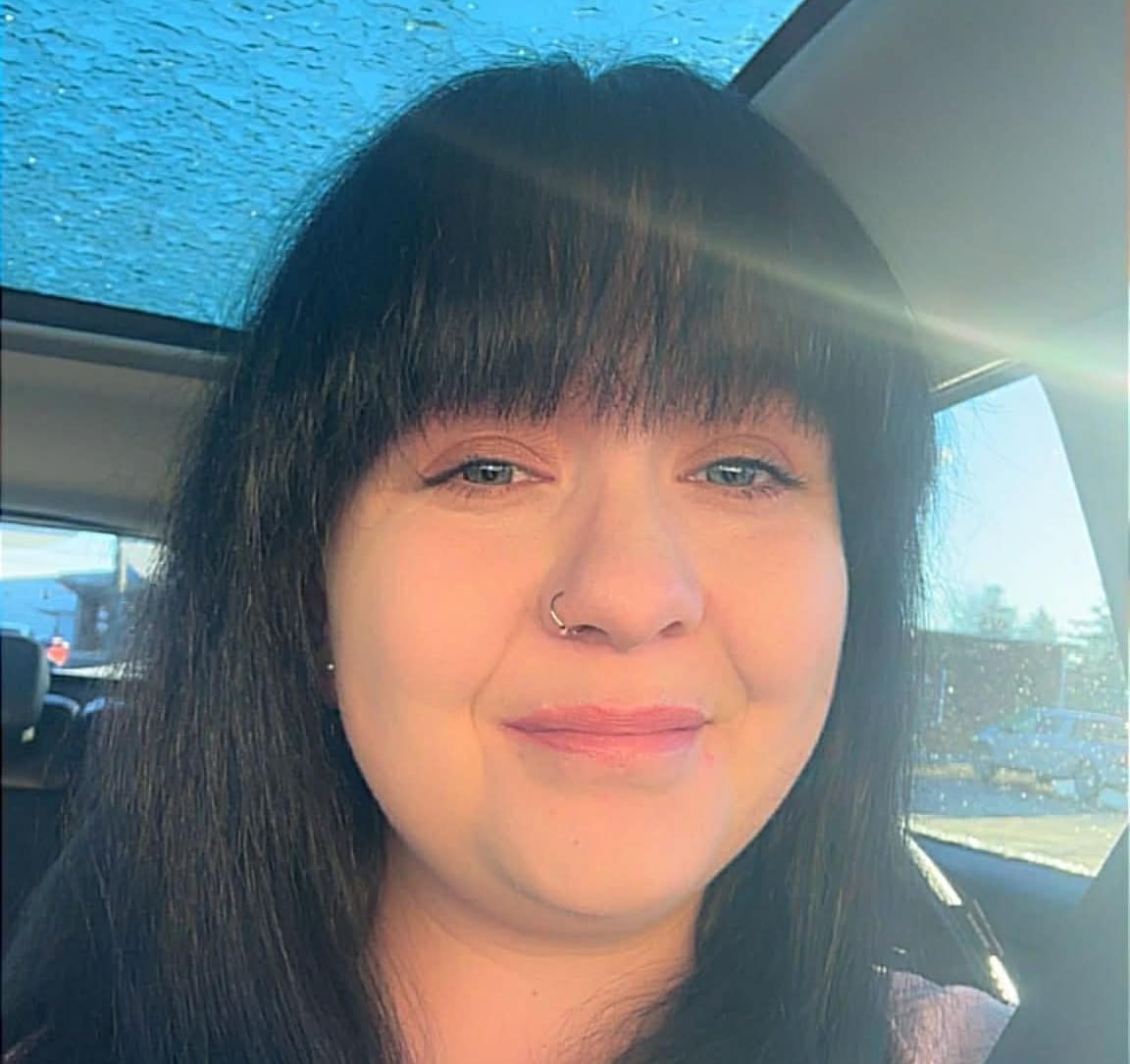 A woman with dark hair and bangs