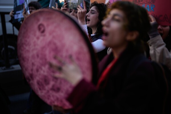 Women shout slogans as they march during a protest marking the International Women's Day, in Istanbul, Turkey, Sunday, March 8, 2026. (AP Photo/Khalil Hamra)