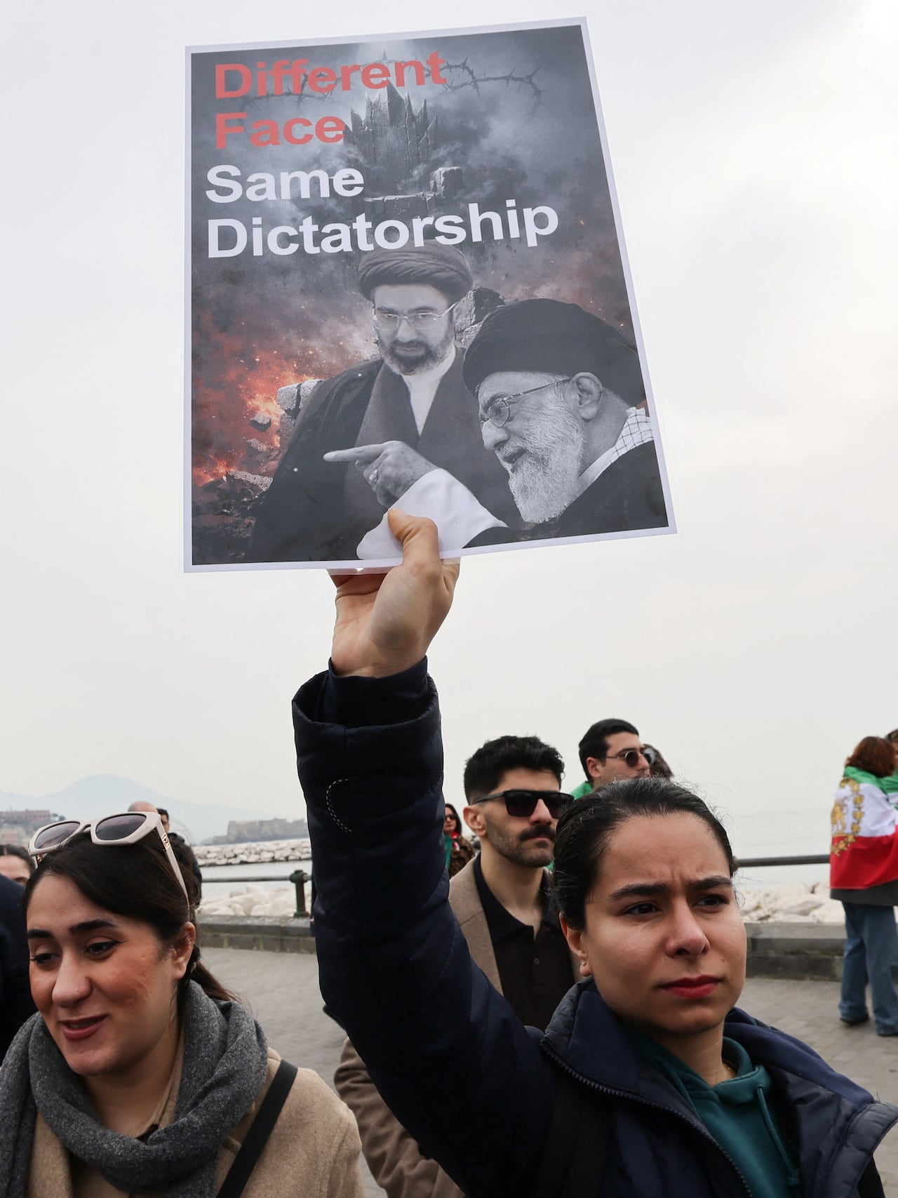 A protester holds up a sign.