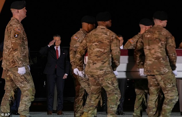 Defense Secretary Pete Hegseth salutes as an U.S. Army carry team moves the transfer case containing the remains of Sgt. Benjamin N. Pennington, 26, of Glendale, Ky., Monday March 9, 2026, at Dover Air Force Base, Del. (AP Photo/Julia Demaree Nikhinson)