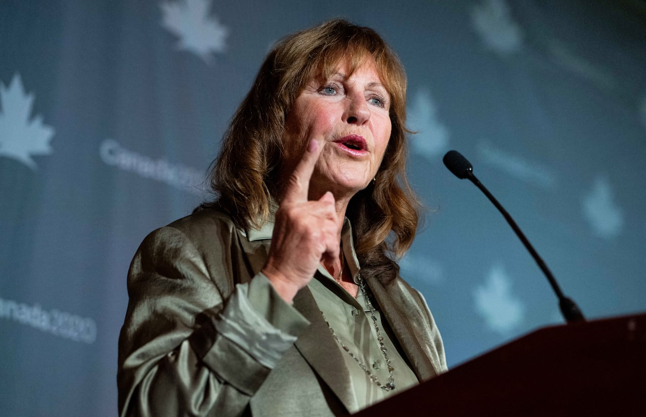 A woman speaks into a microphone.