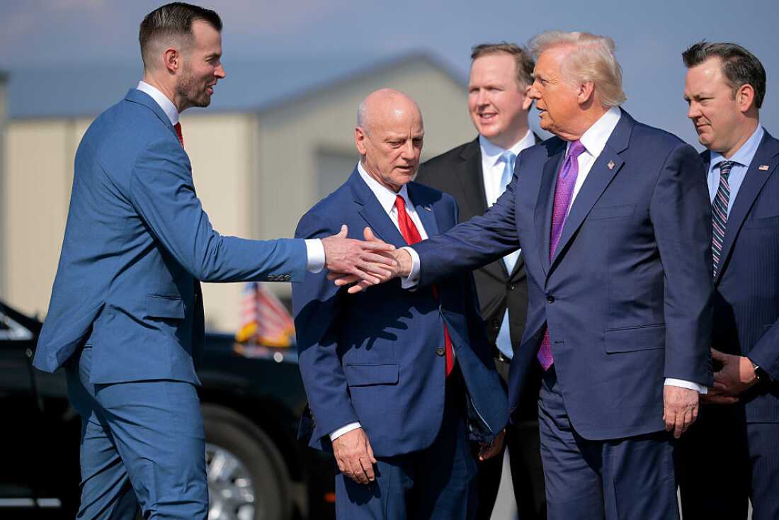 Republican congressional candidate Clay Fuller (left) shakes hands with President Trump as he arrives on Air Force One at Russell Regional Airport on Feb. 19 in Rome, Ga. Trump is in Georgia to visit a steel company and speak on the economy as the state has started voting to replace the seat vacated by former Rep. Marjorie Taylor Greene. (Photo by Chip Somodevilla/Getty Images)
