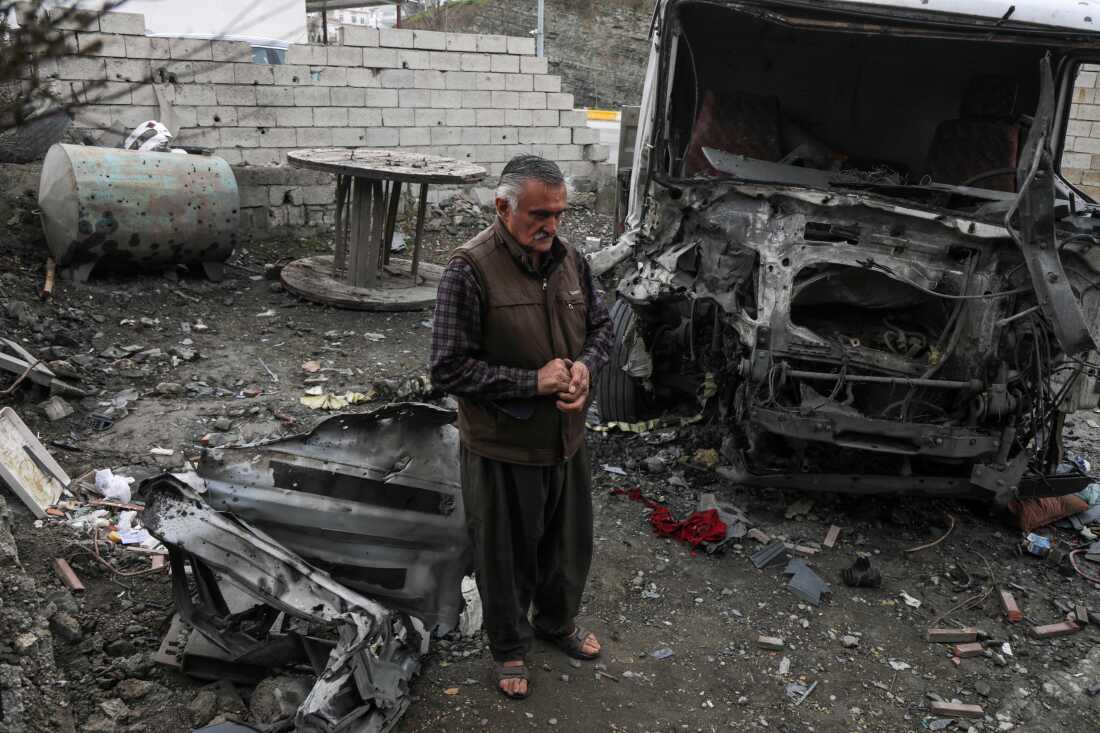 Taha Karimi, 58, a member of the Democratic Party of Iranian Kurdistan (PDKI), stands near his home after it and his truck were damaged in a drone attack carried out by Iran-backed proxies, in the Kurdish town of Soran, about 100 kilometres northeast of Erbil the capital of Iraq's autonomous Kurdish region, on March 8, 2026.
