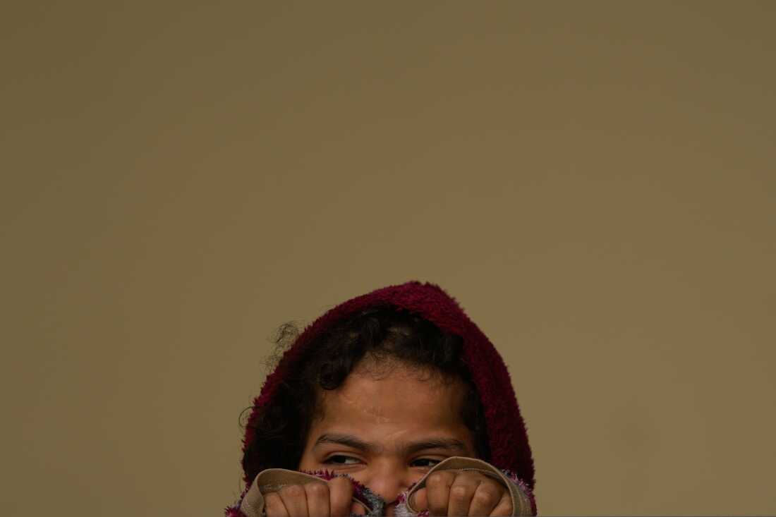 A girl displaced by Israeli airstrikes, looks on at a school used as a shelter in Beirut, Lebanon.