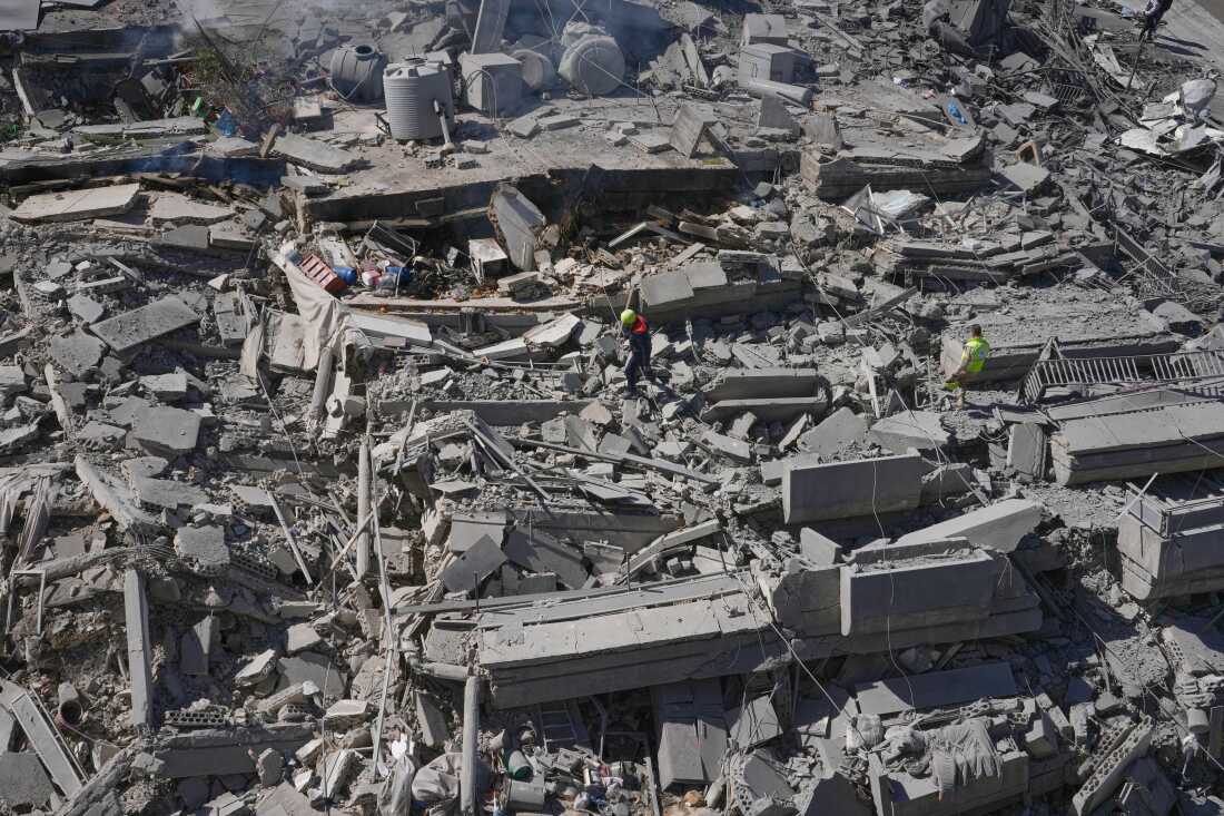 Rescue workers check a destroyed building that was hit by an Israeli airstrike in Nabatiyeh town, south Lebanon.