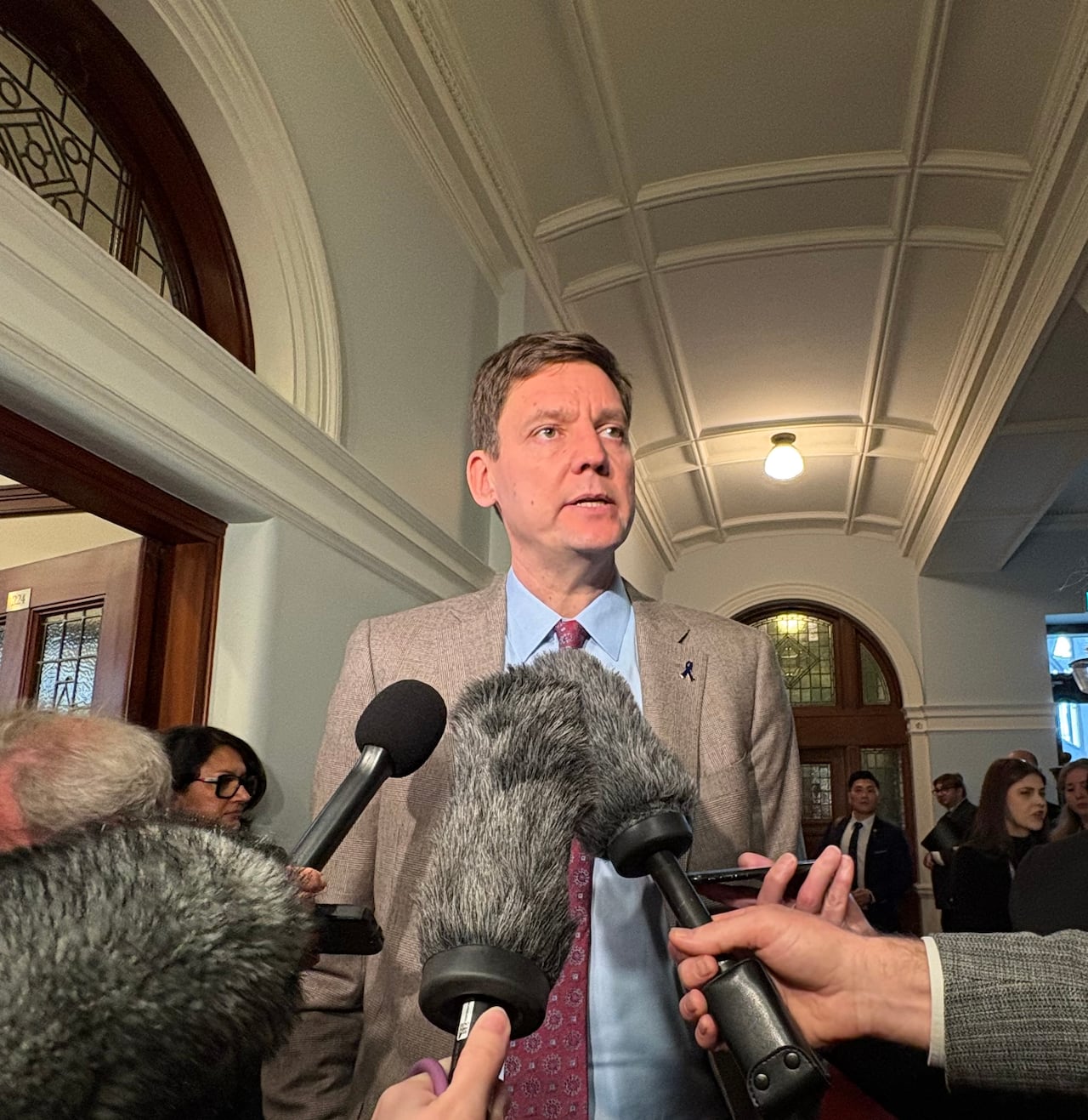 a man stands in front of microphones