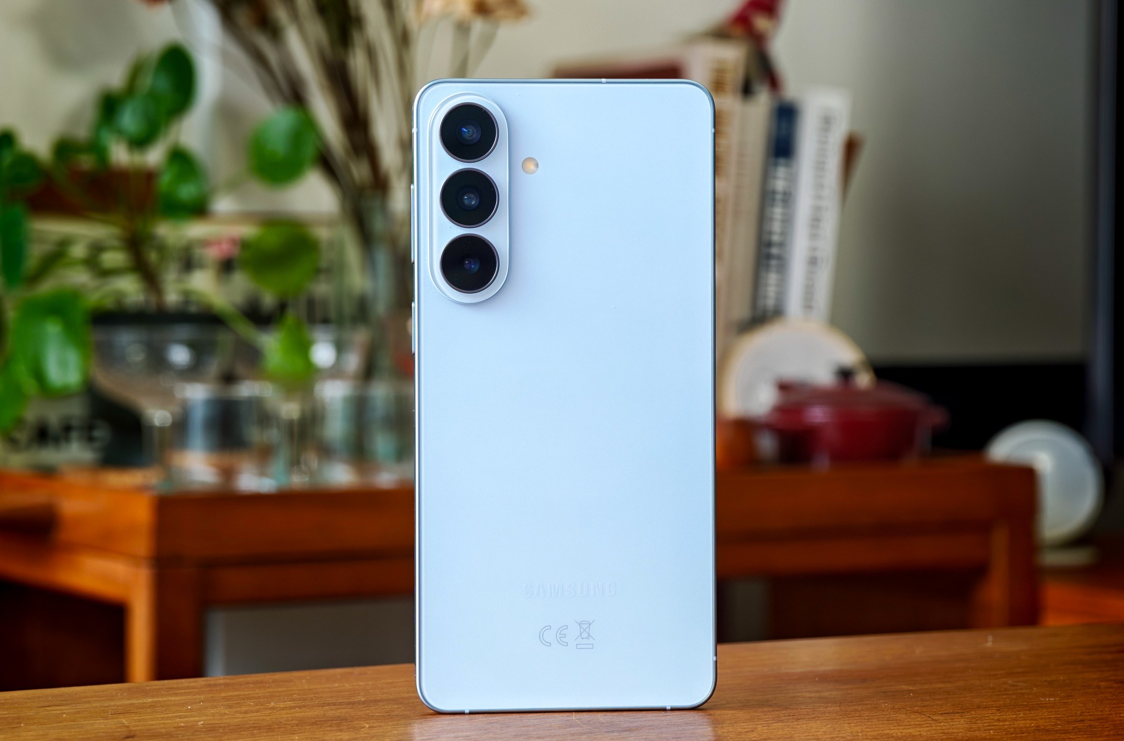 Photo of blue Samsung Galaxy S26 Plus on a wooden table