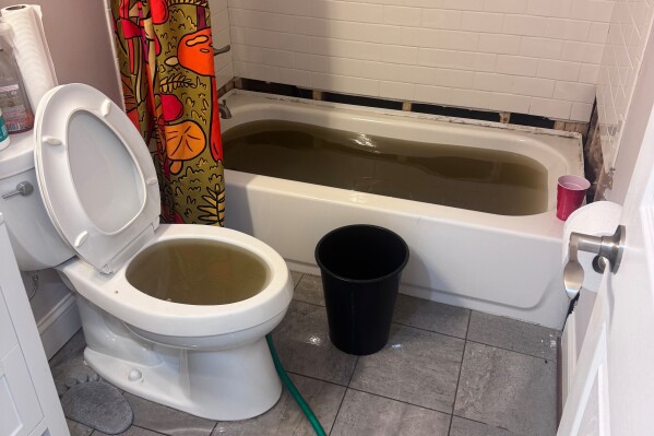 In this image provided by John Craig Senatore, sewage backup is visible in his bathroom on Jan. 27, 2026, in Baltimore. (John Craig Senatore via AP)