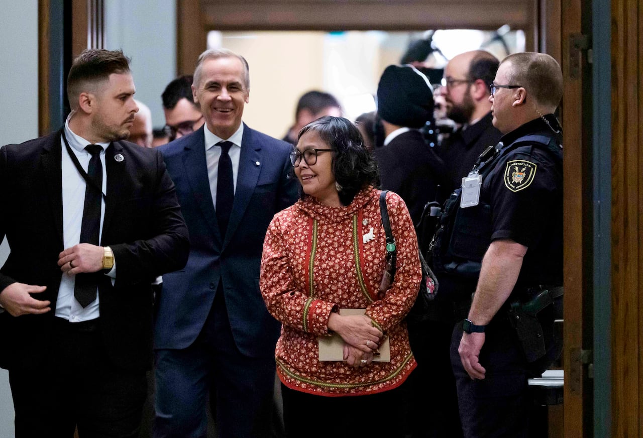 Prime Minister Mark Carney arrives with MP for Nunavut Lori Idlout, who crossed the floor from the NDP to the Liberals, as they make their way to a meeting of the Liberal caucus on Parliament Hill in Ottawa, on Wednesday, March 11, 2026.