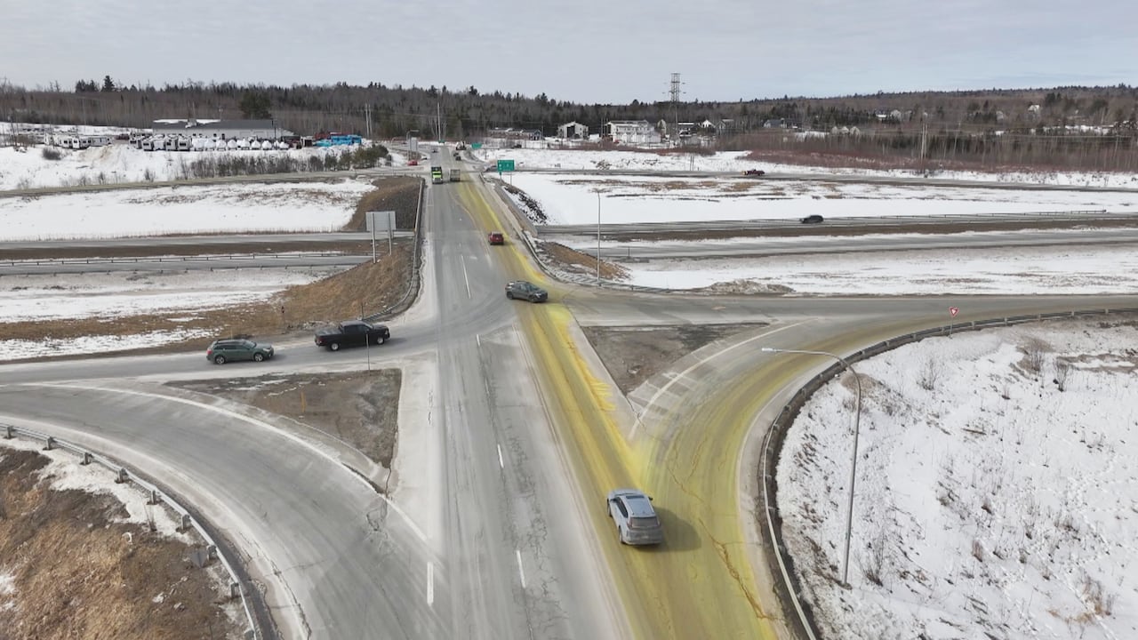 An aerial view of a a road covered in a yellow substance.