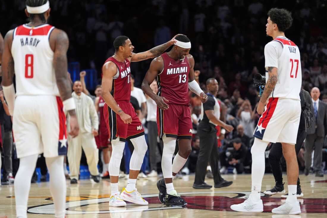 Miami Heat center Bam Adebayo (13) is congratulated by forward Keshad Johnson (16) after reaching 83 points, the second-highest single game total in NBA history, in the second half of an NBA basketball game against the Washington Wizards, Tuesday, March 10, 2026, in Miami.