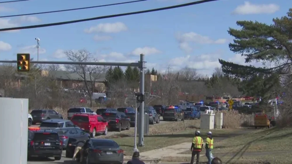 Emergency crew cars line up and crowd the street near Temple Israel on March 12, 2026, in West Bloomfield Michigan.