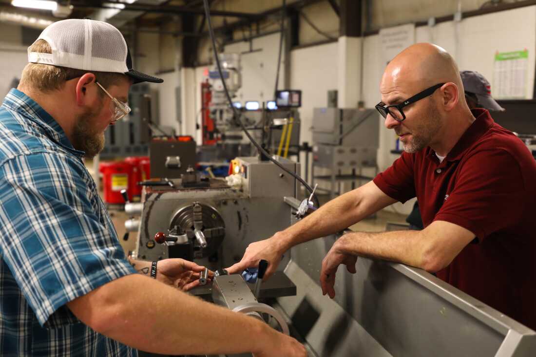 Moss (left) spends two days a week in Matt Walrond's Machining II class at Pulaski Technical College in North Little Rock.