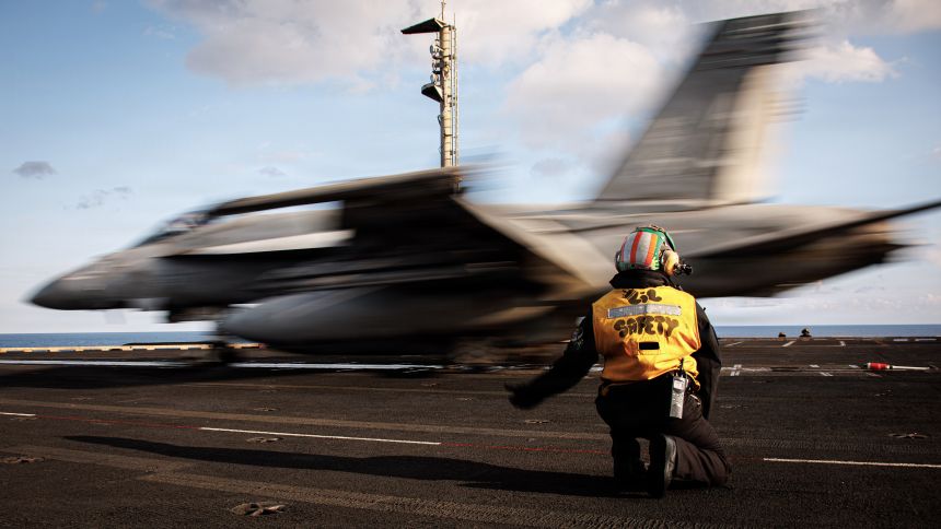 A sailor signals the launch of an F/A-18E Super Hornet aircraft, attached to Strike Fighter Squadron 37, aboard the USS Gerald R. Ford (CVN 78), while operating in support of Operation Epic Fury on March 2, 2026.