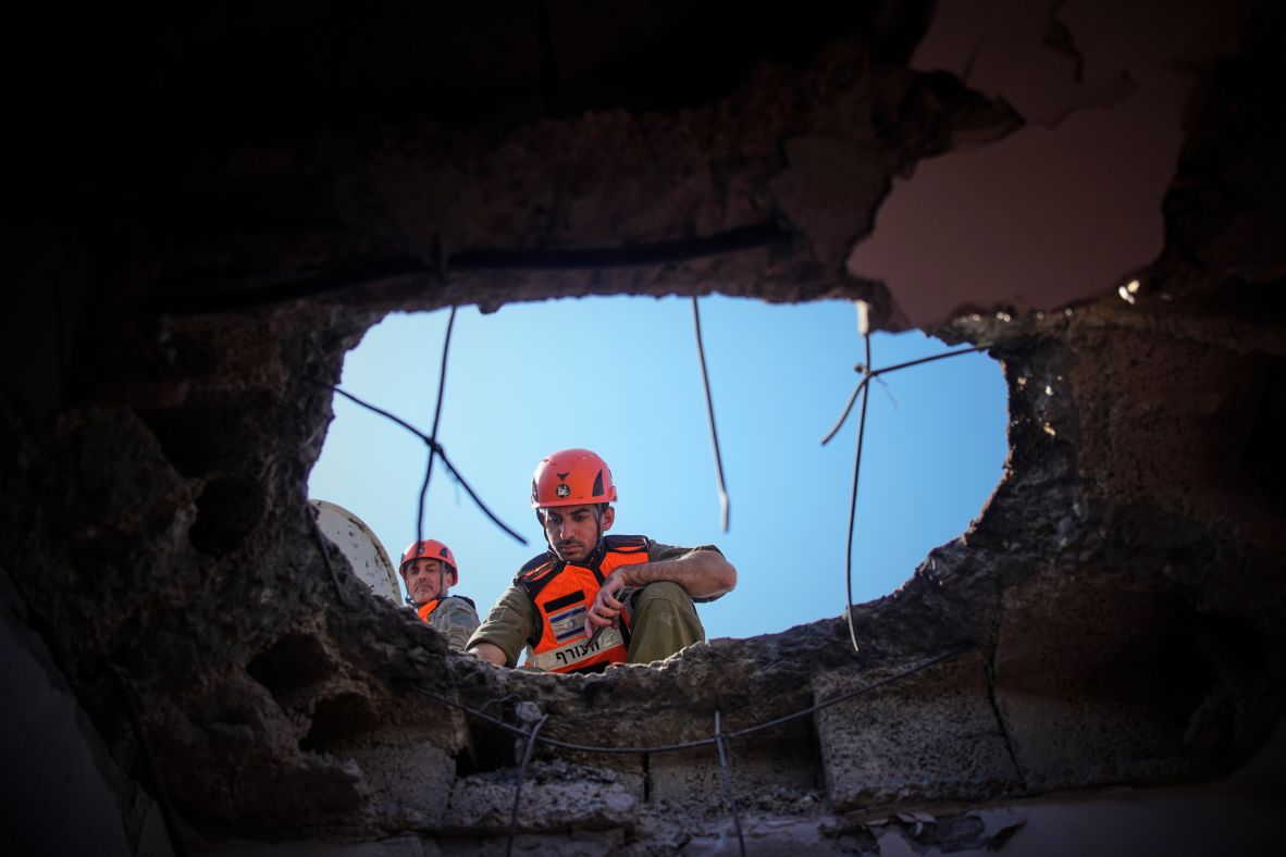 Officers from Israel's Home Front Command inspect a damaged apartment building after an Iranian missile strike in Petah Tikva, Israel, on Tuesday.