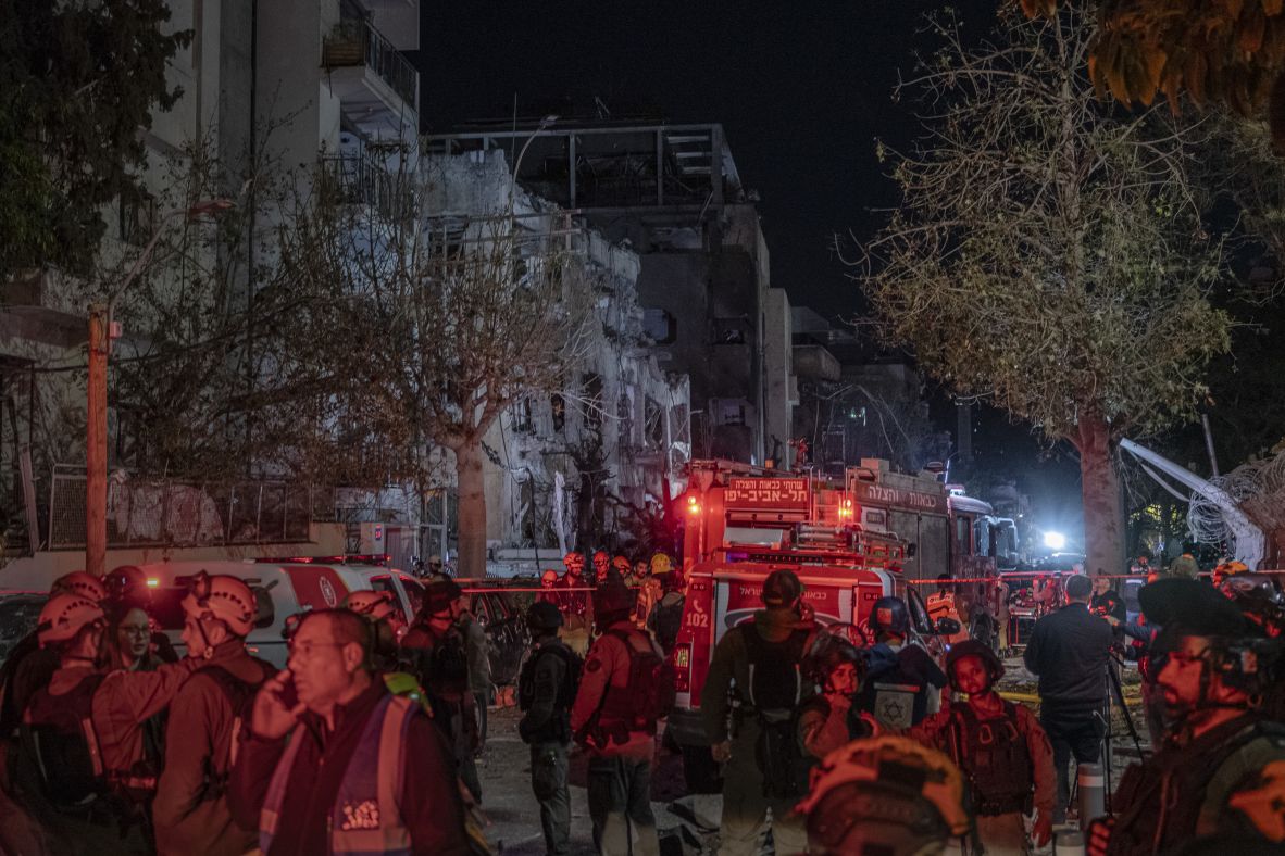 Emergency responders and residents gather at the site of a reported Iranian missile strike in central Israel on February 28.