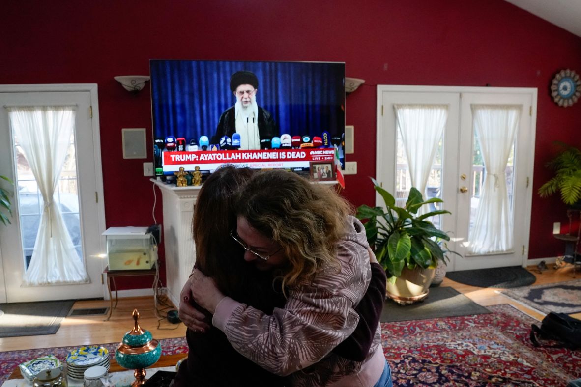 Sadaf Ebrahimi and Shirin Nariman, supporters of the National Council of Resistance of Iran, react to reports of Khamenei's death as they watch the news at Nariman's home in Vienna, Virginia.