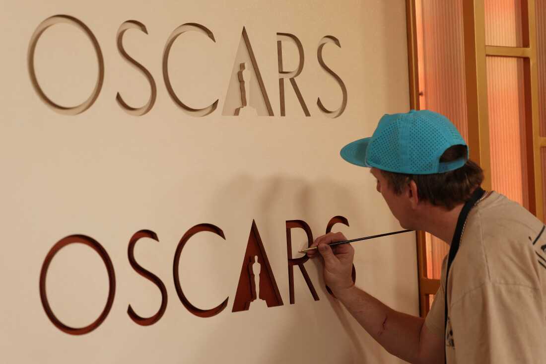 A worker retouches the backdrop as preparations are made on the red carpet arrivals area ahead of the 98th Annual Academy Awards in Hollywood, Calif., on March 13.