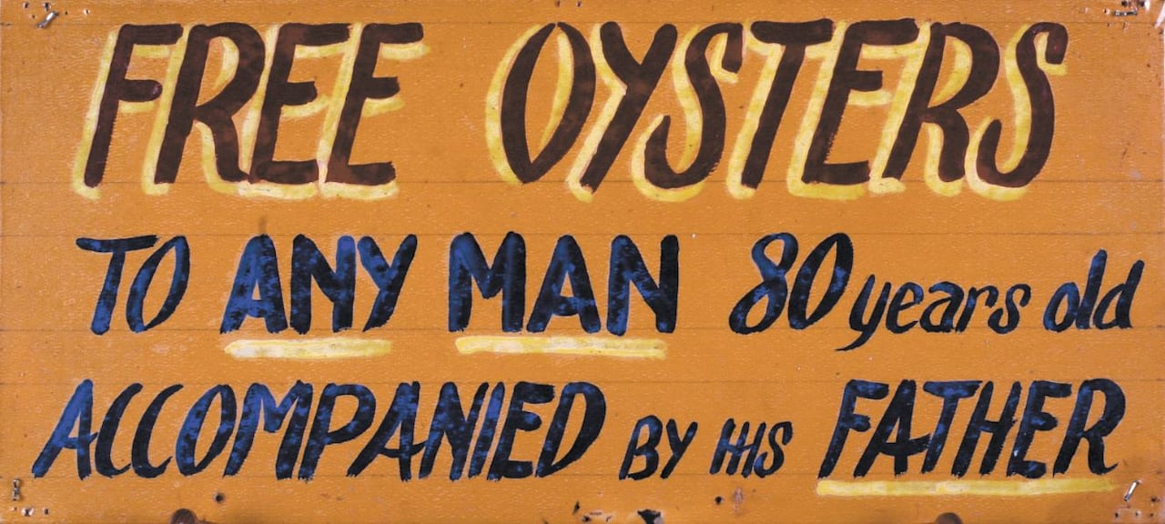 A picture of an old sign that reads "free oysters to any man 80-years-old accompanied by his father."