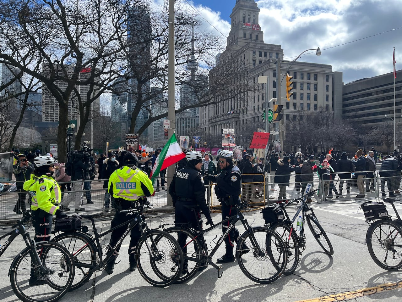 Police officers with bikes standing near rally