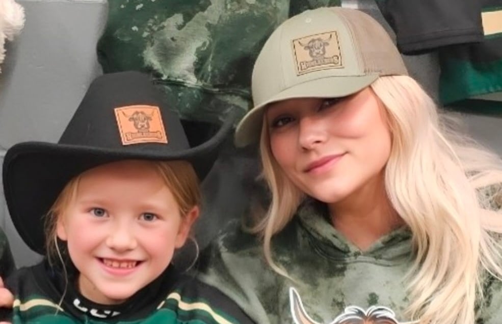 A mother and her daughter pose for a photo.