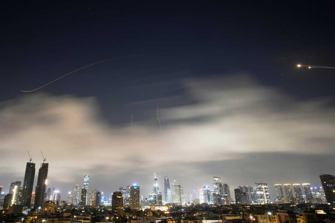 Israeli air defense system fires to intercept missiles during an Iranian attack over Tel Aviv, Israel, early Sunday, March 15, 2026.