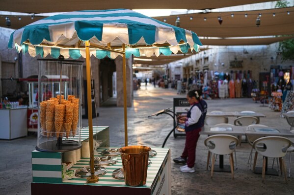 An ice cream stand sits in empty Al Seef market, next to the historic Al Fahidi neighborhood along Dubai Creek, one of the main tourist areas of Dubai, United Arab Emirates, Friday, March 13, 2026, as tourism slows amid regional tensions linked to the Iran war. (AP Photo/Fatima Shbair)
