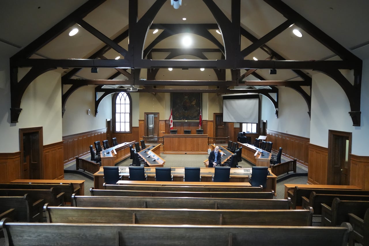 A man stands in a county council chamber.