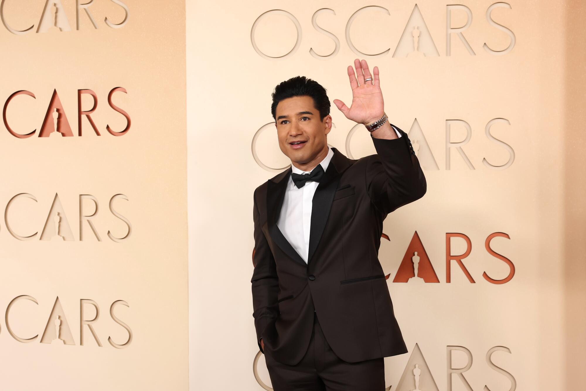 Mario Lopez waves to the cameras. 