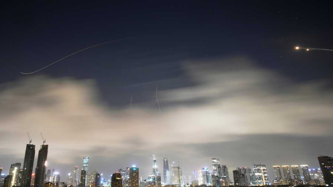 Israeli air defense system fires to intercept missiles during an Iranian attack over Tel Aviv, Israel, early Sunday, March 15, 2026.