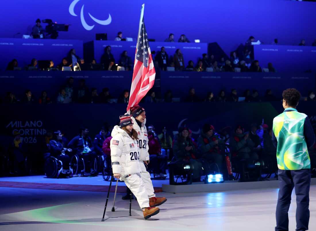 Andrew Kurka and Kendall Gretsch carry the U.S. flag during the Milano Cortina 2026 Winter Paralympic Games closing ceremony in Cortina on Sunday.
