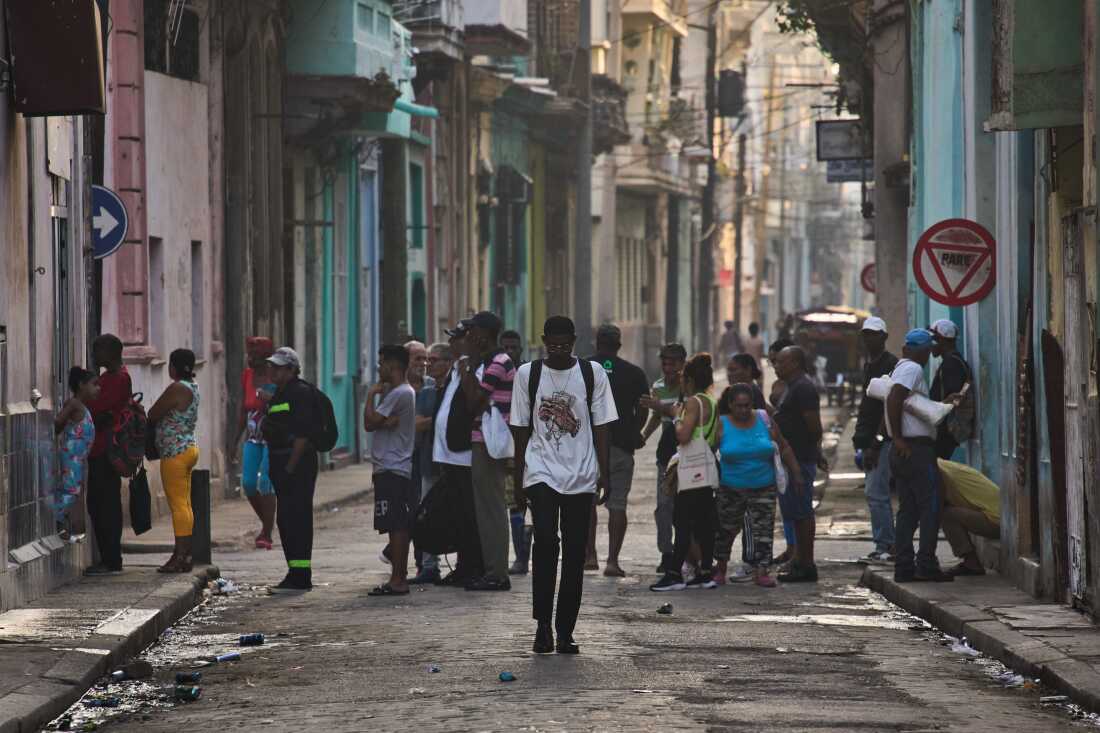 People line up in the street to buy bread in Havana, Cuba, Friday, March 13, 2026.
