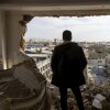 TEHRAN, IRAN - MARCH 14: A man stands in a damaged residence on March 14, 2026 at the site of buildings, including a police station, that were destroyed in an airstrike two days ago in the Khani Abad neighbourhood of Tehran, Iran. According to authorities, the police station was empty at the time of the attack but six civilians were killed. The United States and Israel have continued a campaign of air strikes in Iran after launching their joint war on the country on February 28.(Photo by Majid Saeedi/Getty Images)