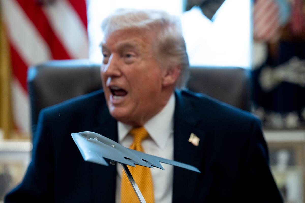 A model stealth bomber in front of US President Donald Trump during an executive order signing