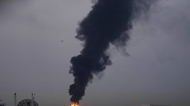 Fire and plumes of smoke rises after s drone struck...