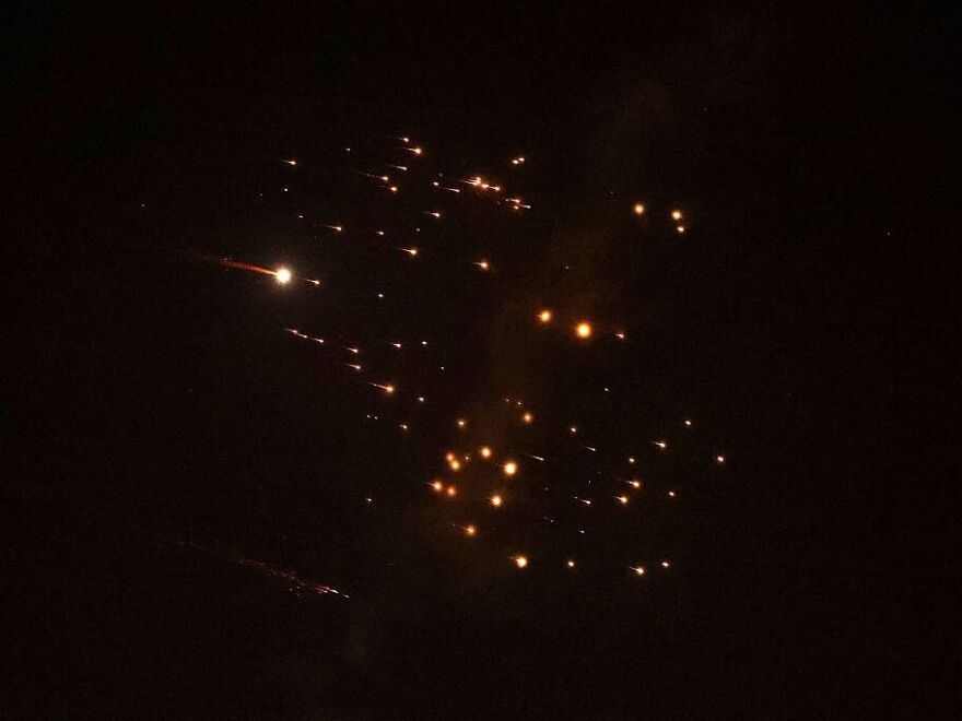 Rocket trails are seen in the sky amid a fresh barrage of Iranian missile attacks above the Israeli coastal city of Netanya on March 18, 2026.