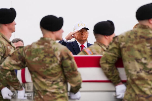 President Donald Trump salutes as an Army carry team moves a flag-draped transfer case during a casualty return on March 7, 2026, at Dover Air Force Base, Delaware. (AP Photo/Julia Demaree Nikhinson, File)