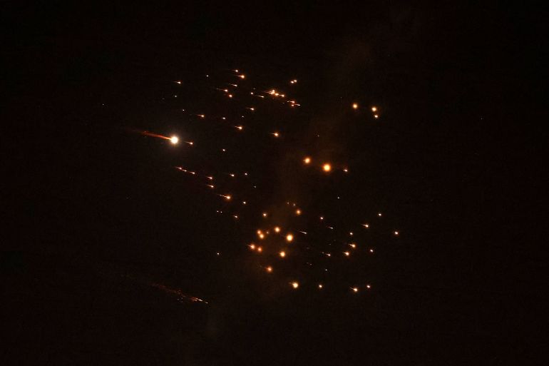 Rocket trails are seen in the sky amid a barrage of missile attacks.