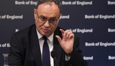 Bank of England headquarters with digital currency symbols, highlighting new stablecoin regulation changes in the UK market