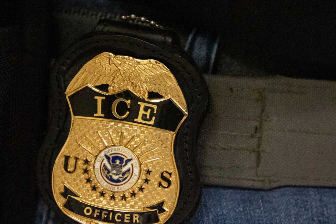 FILE - A federal agent wears an Immigration and Customs Enforcement badge in New York, June 10, 2025.