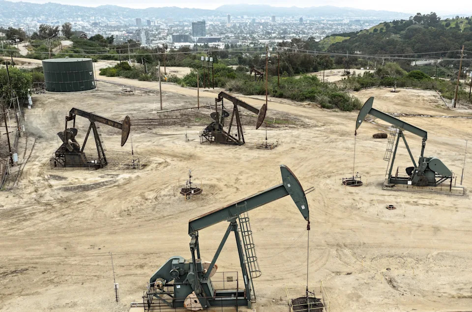 An aerial view as oil pumpjacks operate while others stand idle in the Inglewood Oil Field on March 10, 2026 near Los Angeles, California. 