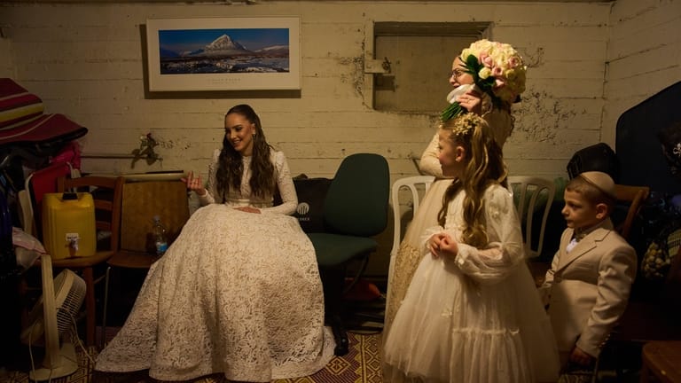 A bride and her family in the midst of a...
