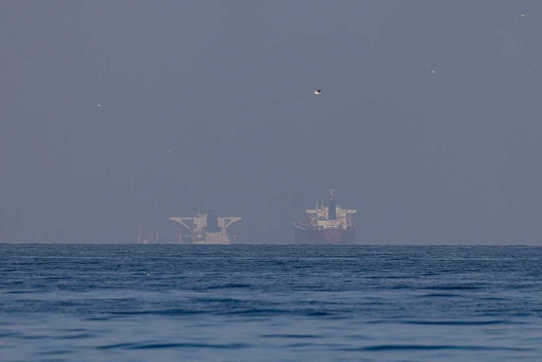 Commercial vessels in the Gulf, near the Strait of Hormuz on March 22, 2026 in northern Ras al Khaimah, United Arab Emirates.