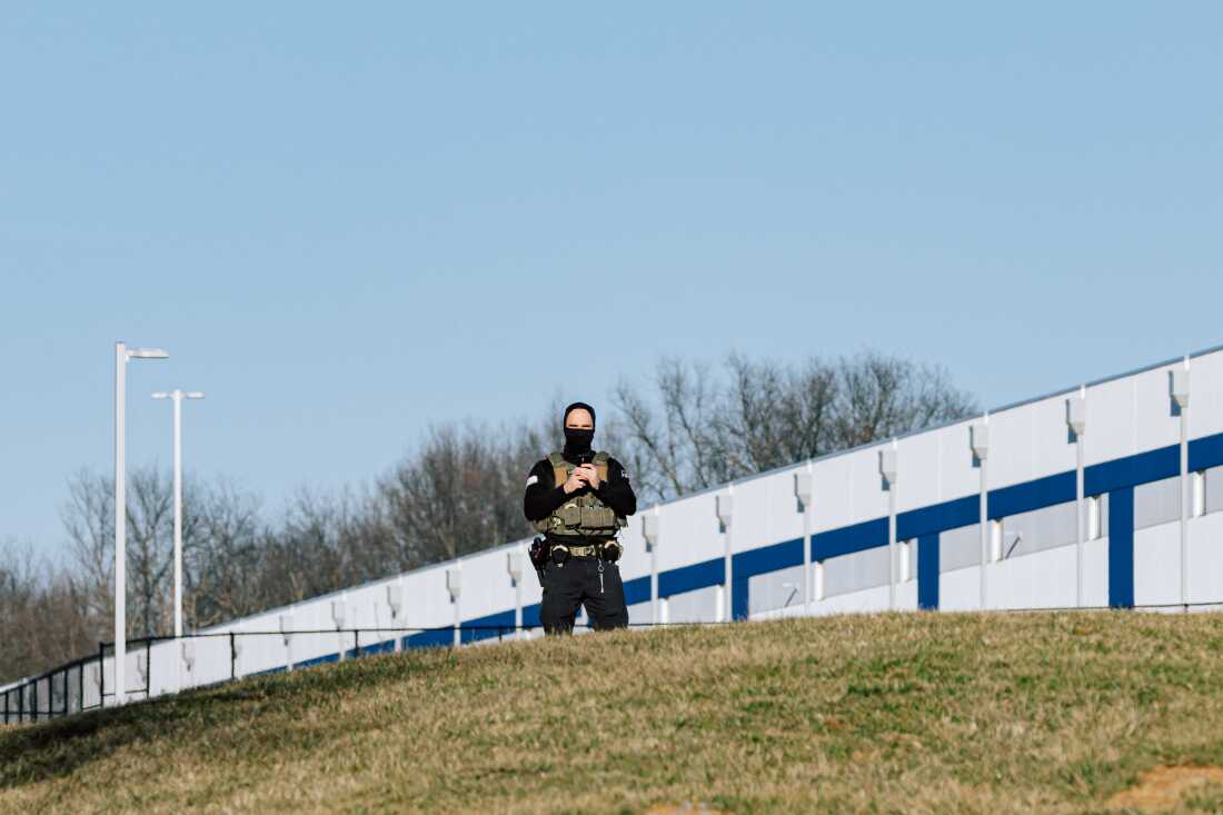 An Immigration and Customs Enforcement worker stands outside a warehouse in Williamsport, Md., that's being converted into an immigration detention center with plans to hold 1,500 people, on March 9.