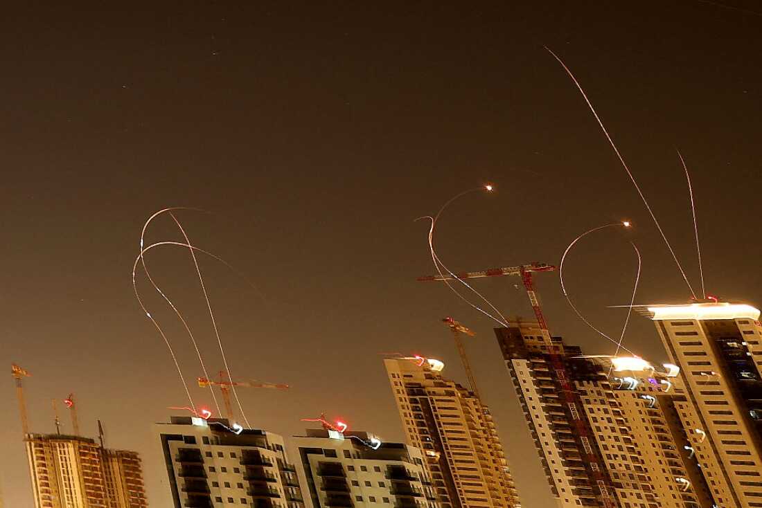 Rocket trails are seen in the sky above the Israeli coastal city of Netanya amid a fresh barrage of Iranian missile attacks on March 24, 2026.