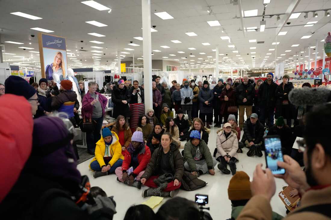 Community members and neighbors of people detained by ICE gather in protest at a Target store, on Jan. 19, 2026, in St. Paul, Minn.